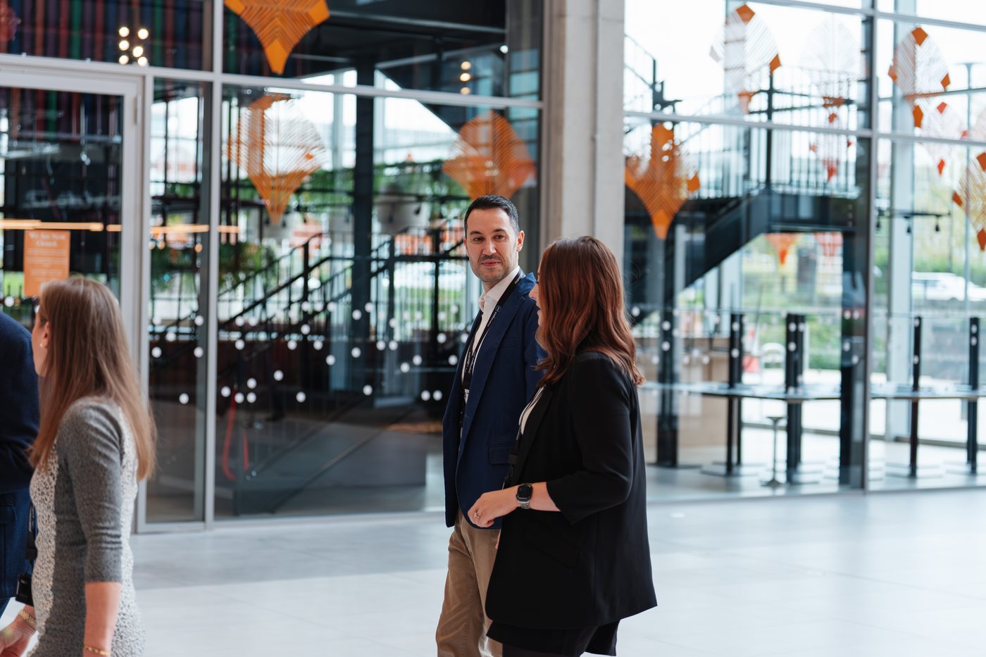 Two channel partners in conversation in a modern venue